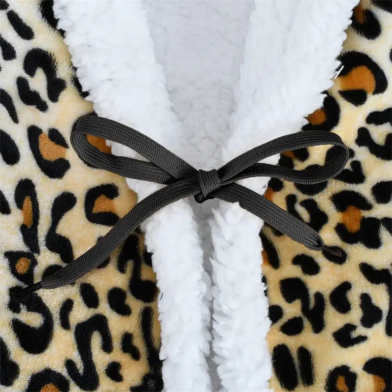 A cozy leopard print warm wearable fleece robe with white sherpa lining and black ribbon bow by decorbites