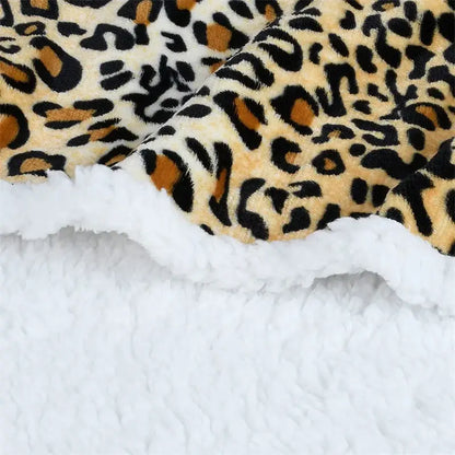 Faux fur leopard print warm wearable hooded blanket with black tan cream tones and plush white sherpa lining decorbites