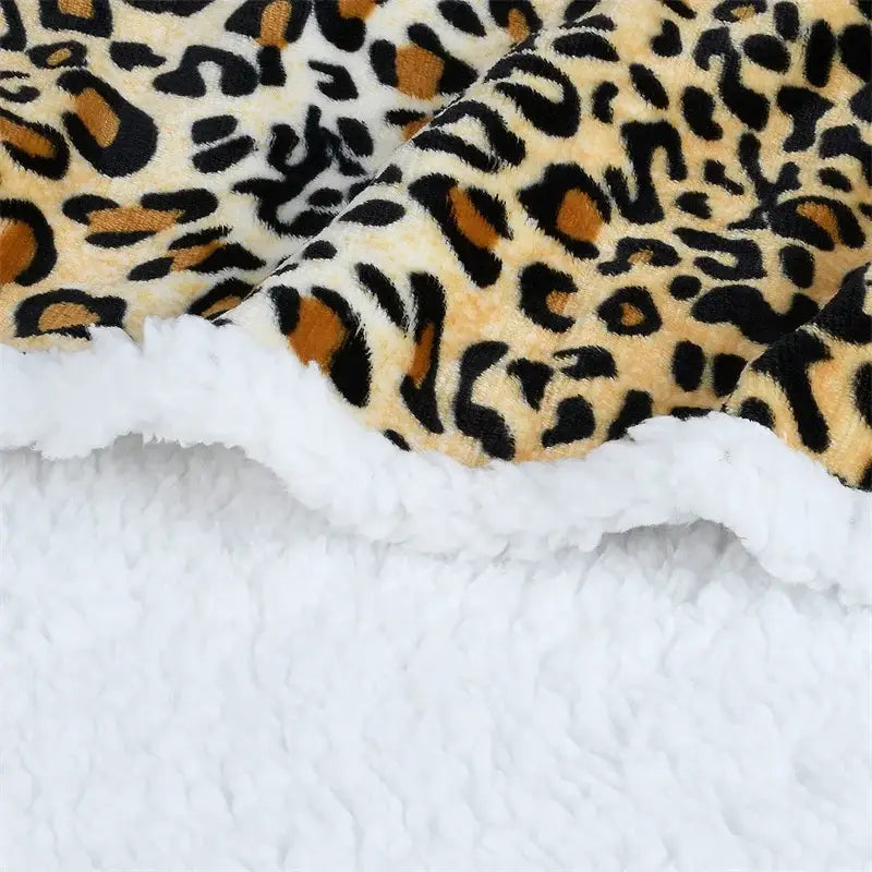 Faux fur leopard print warm wearable hooded blanket with black tan cream tones and plush white sherpa lining decorbites