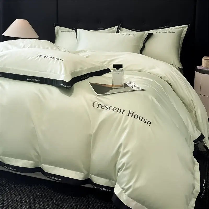 Cream-colored satin duvet cover bed set with black trim and crescent house branding decorbites ice silk material