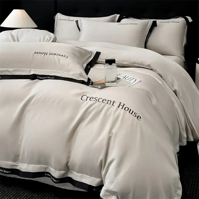 Cream-colored satin bed set with black trim and crescent house embroidery in decorbites ice silk duvet cover