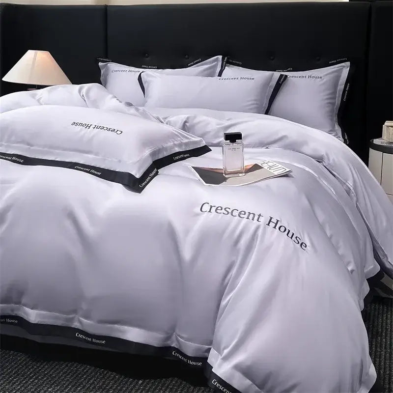 Silver satin duvet cover set with black trim and crescent house branding for decorbites ice silk bed set