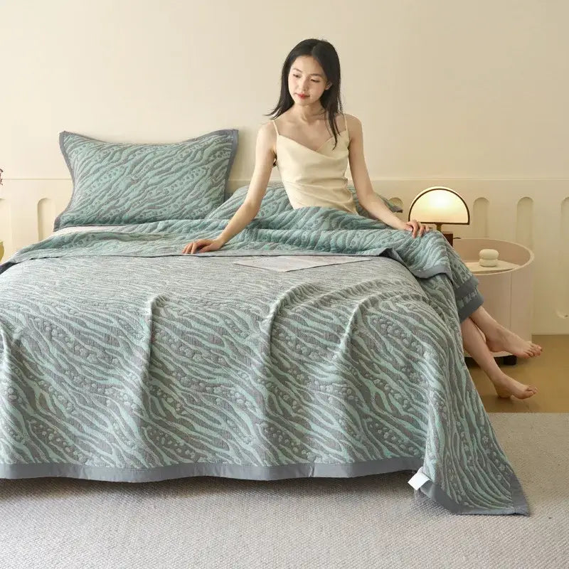 A soft mint green decorbites cotton summer cool quilt with wave pattern and gray border towel blanket