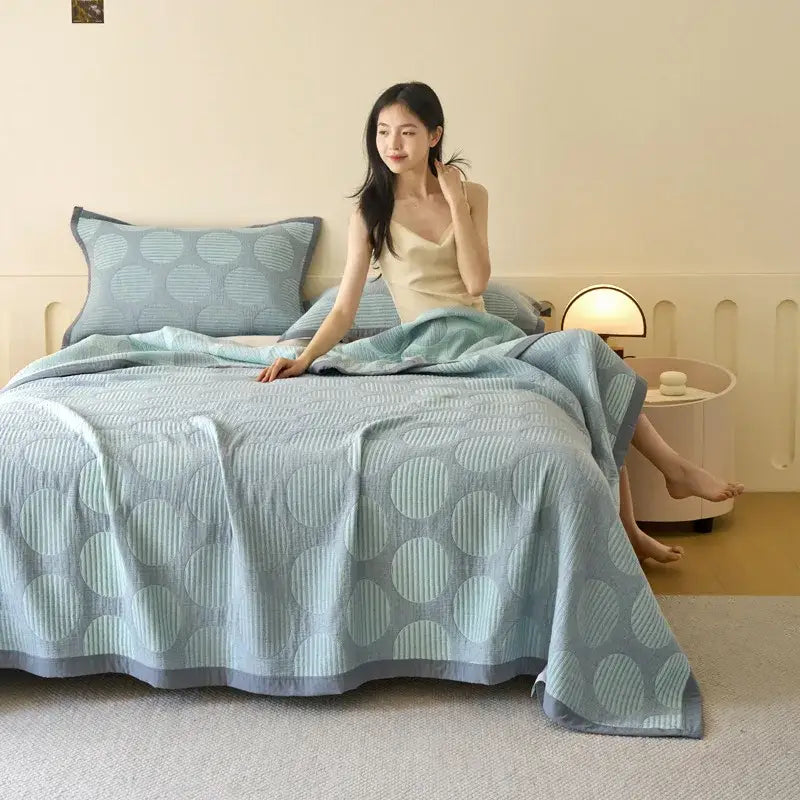 Light blue and gray decorbites cotton summer cool quilt towel blanket with circular patterns and subtle striped texture