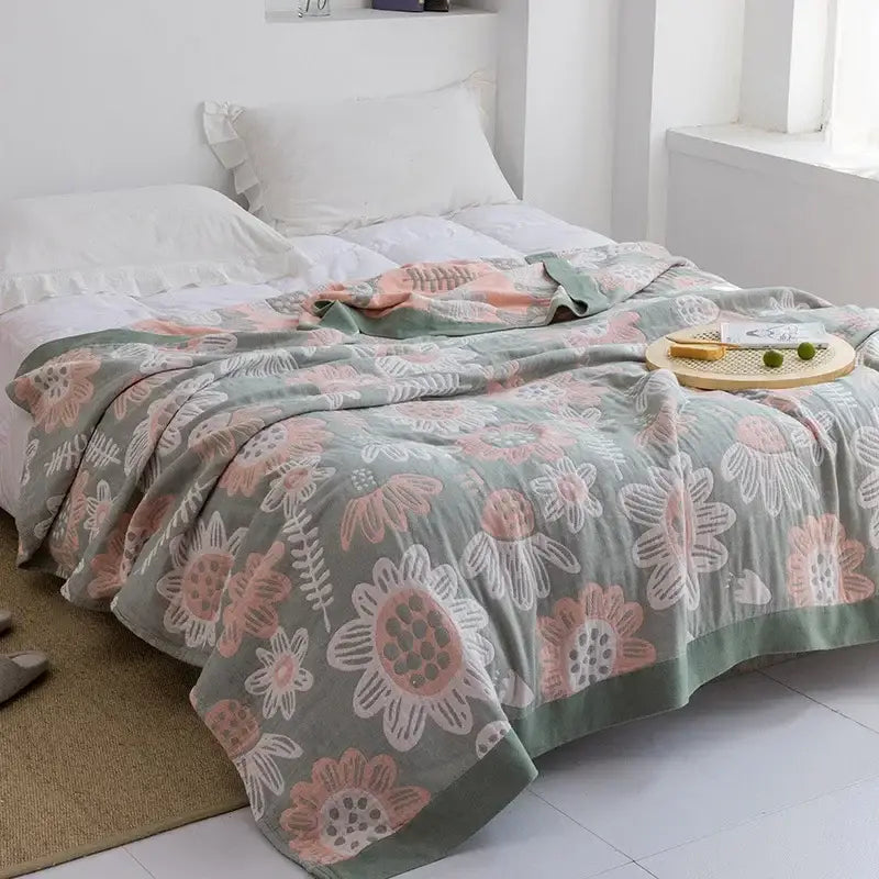 A soft mint green decorbites cotton gauze towel throw with blush pink and white floral pattern for bedroom decor