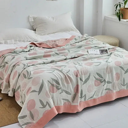 Light blue and white leaf cotton gauze towel throw with peach-toned cotton gauze towel featuring pink peaches decorbites cotton gauze