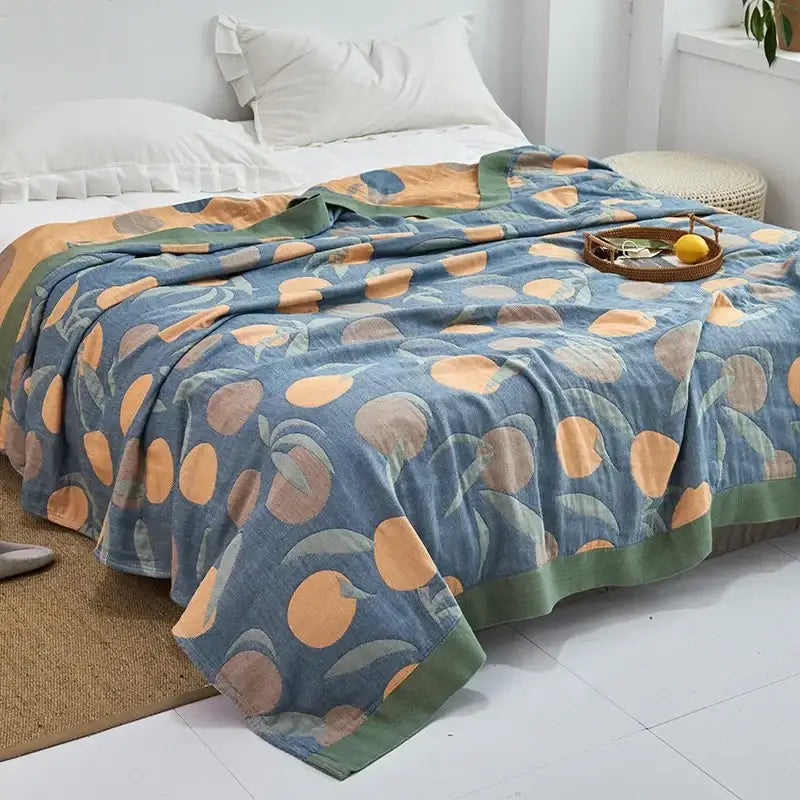 Light blue and white leaf cotton gauze towel throw with soft textured fabric featuring orange peaches decorbites cotton gauze