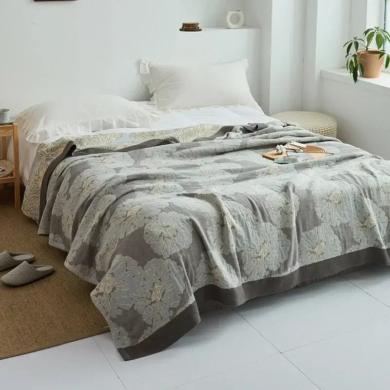 A soft gray floral decorbites cotton gauze towel throw with textured pattern and dark gray border for bedroom decor