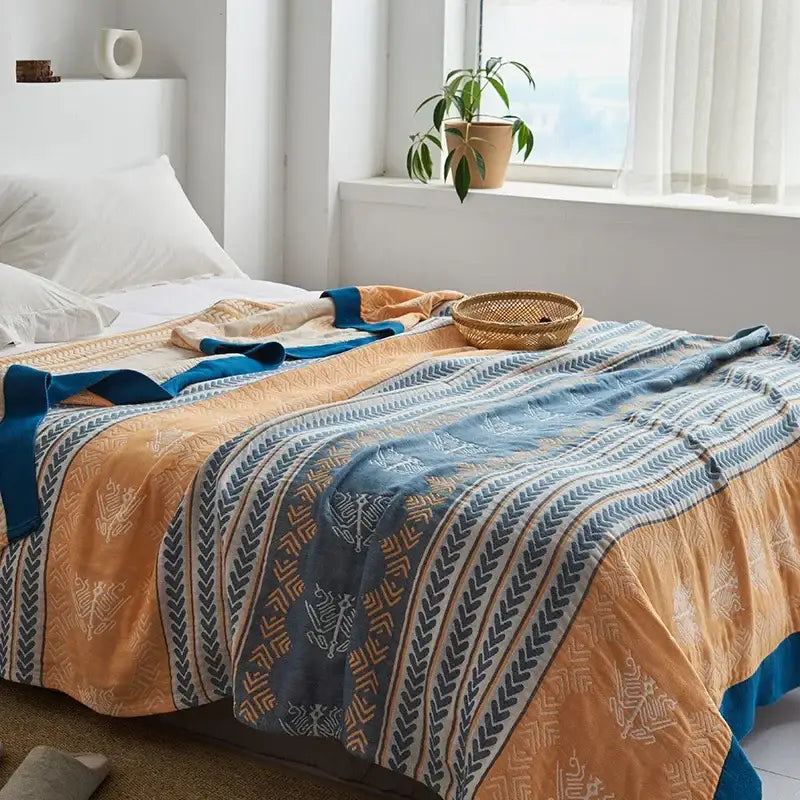 Light blue and white leaf decorbites cotton gauze towel throw with bold orange and blue striped quilt pattern for bedroom decor