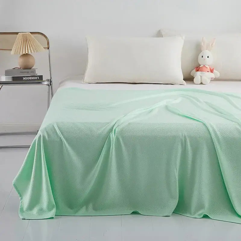 Light blue bamboo fiber summer quilt with a soft mint green textured bedspread featuring a diamond grid pattern