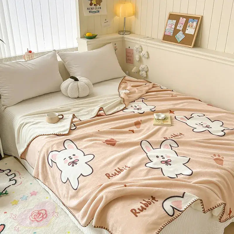Soft peach cozy milk velvet blanket with white cartoon rabbits and playful rabbit print for decorbites cozy milk use