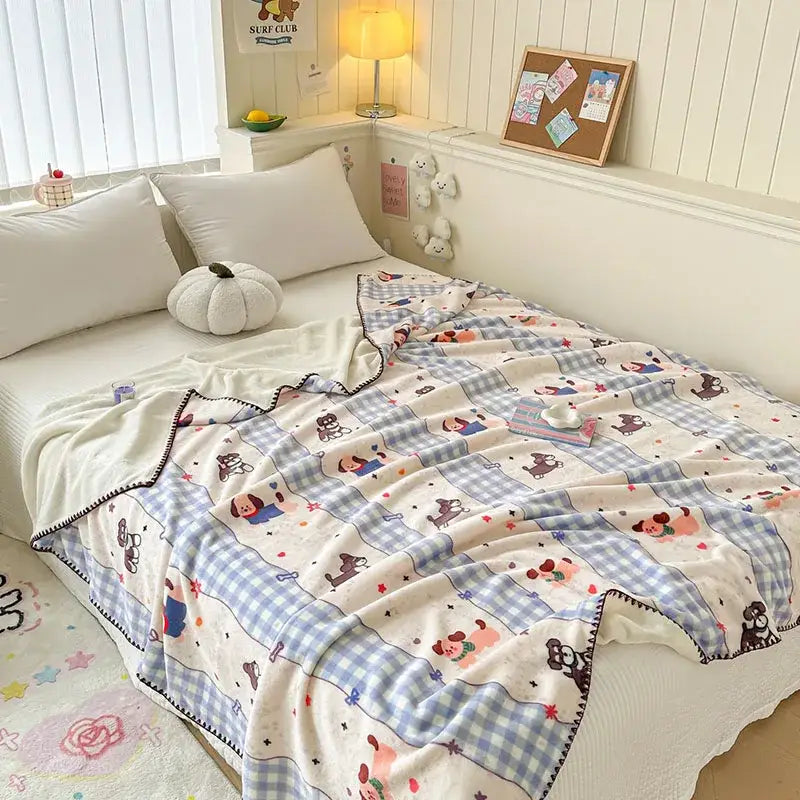 Soft cream milk velvet blanket with cartoon dogs and blue gingham checks edged in black trim by decorbites cozy milk