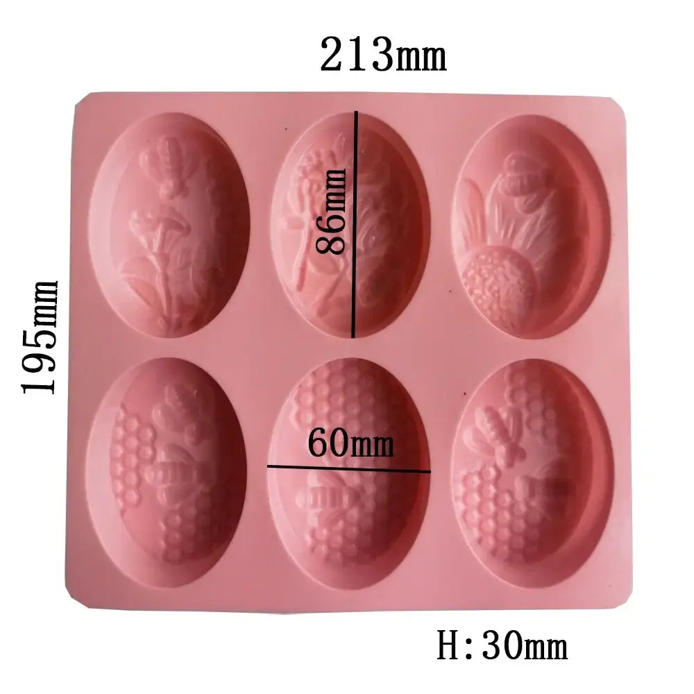Pink silicone egg-shaped soap mold with floral and fruit designs for bee silicone soap and baking use
