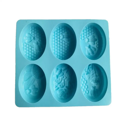 Light blue bee silicone soap mold with six oval cavities featuring intricate honeycomb designs for baking or soap use