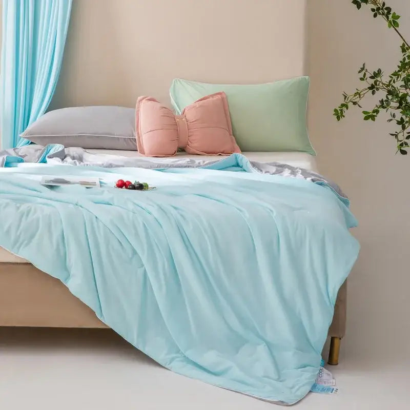 A light blue decorbites cool fiber summer blanket with quilted texture and smooth sheen for bedroom cooling use