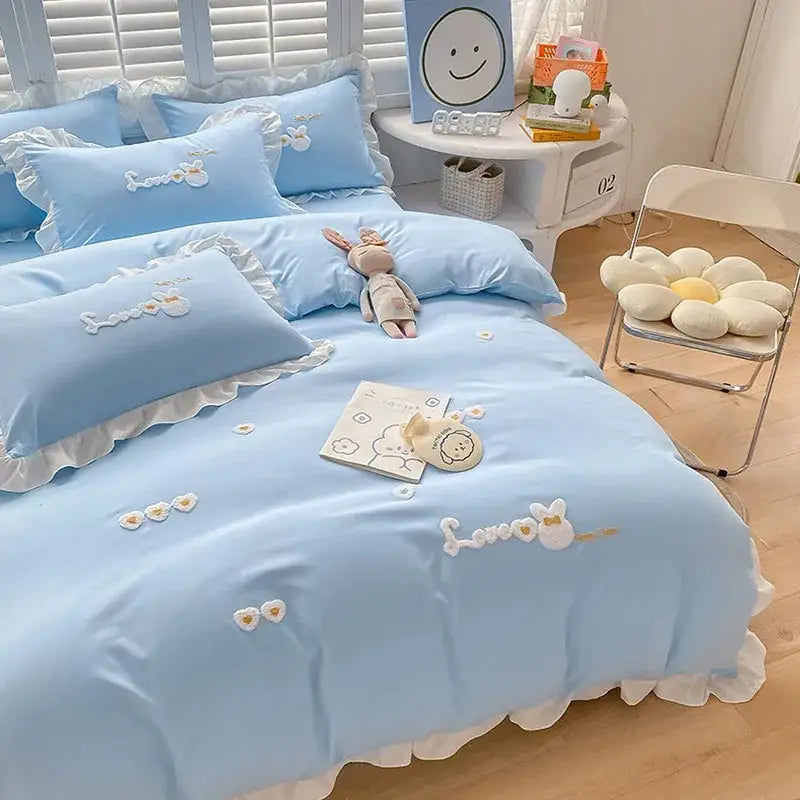 Light blue cotton bedding set with ruffled edges and decorbites cartoon embroidery of bunnies and floral appliqués