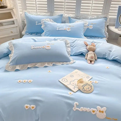 Light blue cotton bedding set with ruffled edges and decorbites cartoon embroidery featuring white bunny motifs