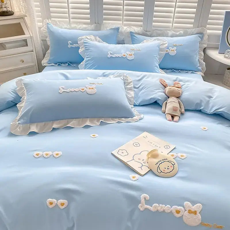 Light blue cotton bedding set with ruffled edges and decorbites cartoon embroidery featuring white bunny motifs
