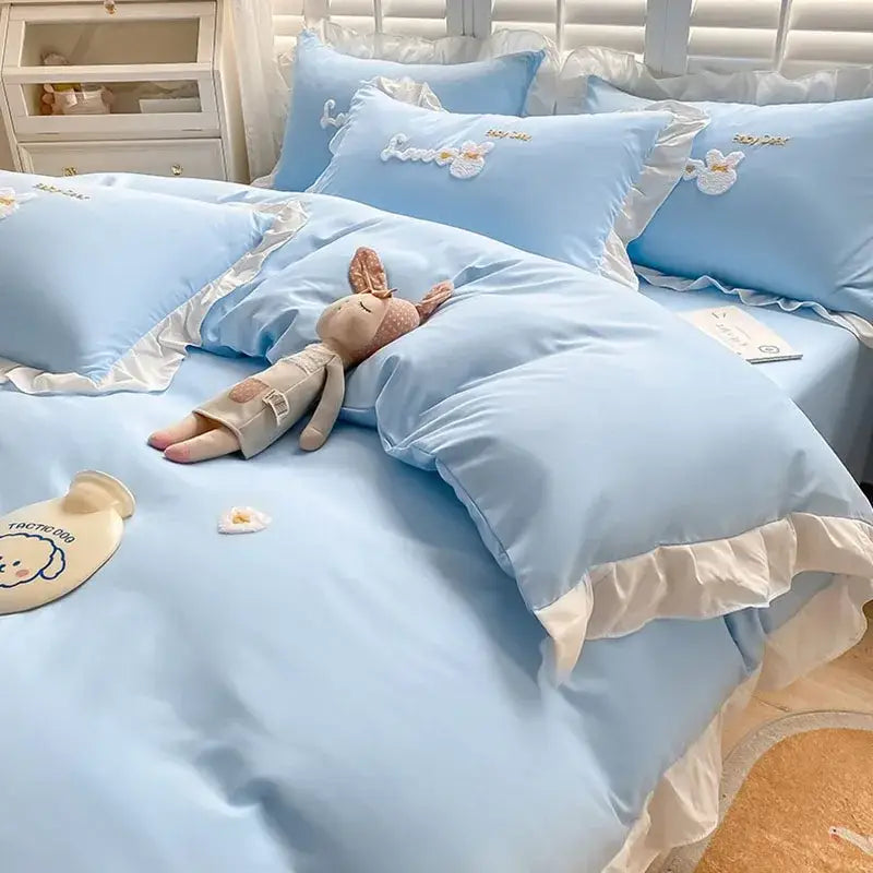 Light blue cotton bedding set with ruffled edges and decorbites cartoon embroidery of floral and bunny designs