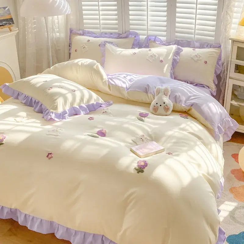 Pastel lavender and cream floral cotton bedding set with ruffled edges complementing light blue bunny embroidery decorbites cartoon bedding set
