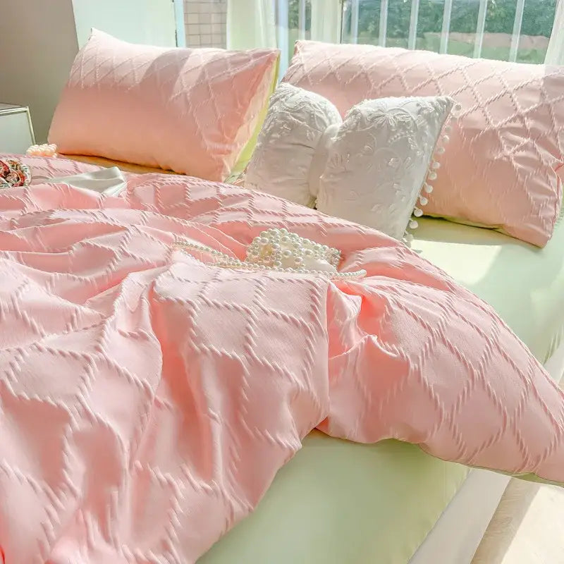 Pink quilted satin duvet cover set with matching pillows and pearl decor complements diamond grid jacquard bedding sets
