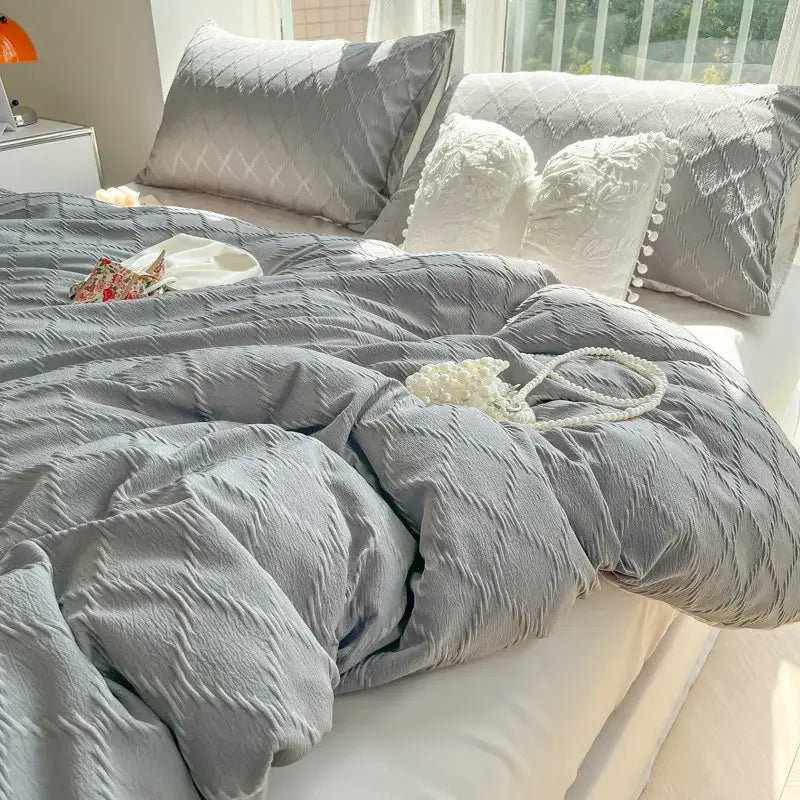 Gray textured quilted duvet cover with a subtle crinkle finish from light blue diamond grid jacquard bedding sets