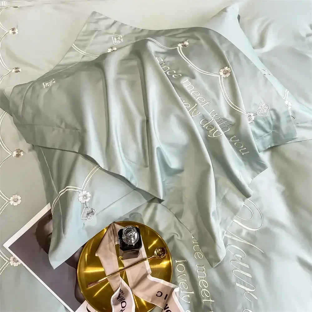 Light blue embroidered egyptian cotton bedding set satin pillowcase with floral motifs and lovely day phrase