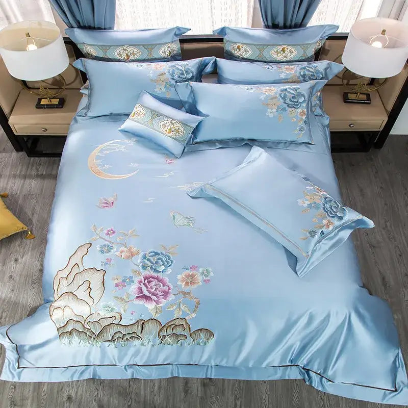 Light blue satin bedding set with intricate floral and moon 200s cotton embroidery accented by gold threads