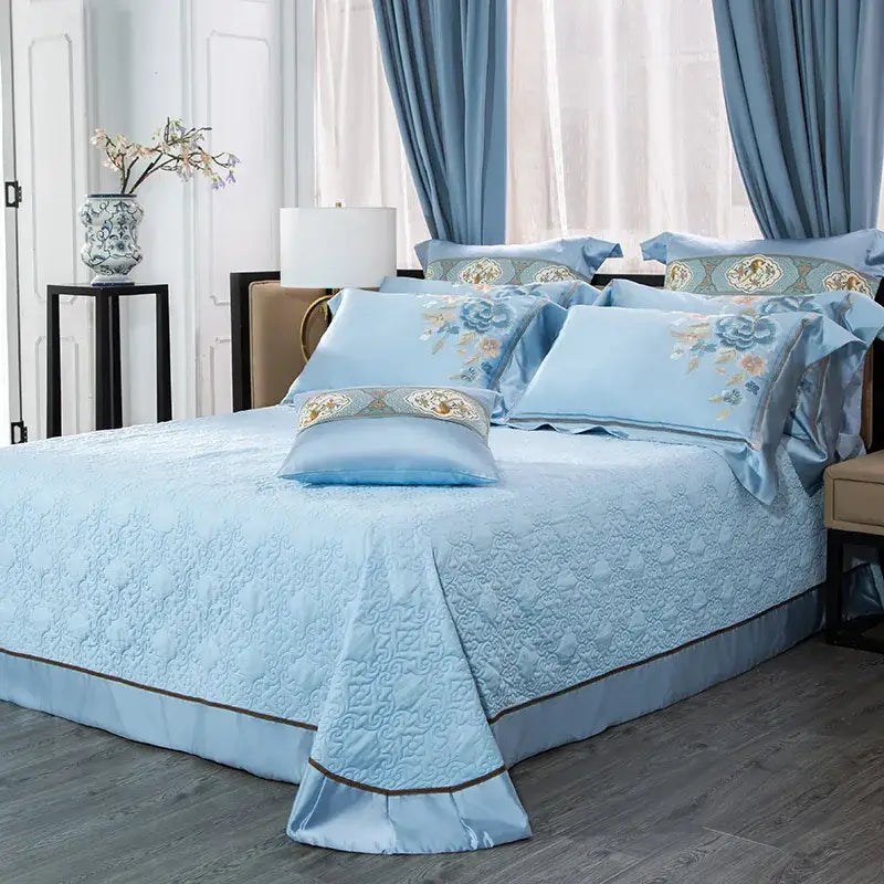 Light blue quilted bedding set with floral and moon 200s cotton embroidery and satin trim for elegant bedroom decor