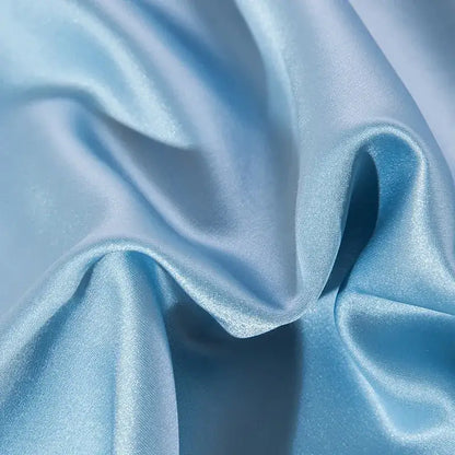 Light blue satin fabric with a smooth glossy finish and gentle folds in 200s cotton embroidery bedding set