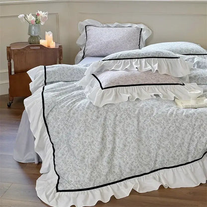 White ruffled decorbites cotton bedding set with delicate gray floral patterns and black trim for bedroom decor