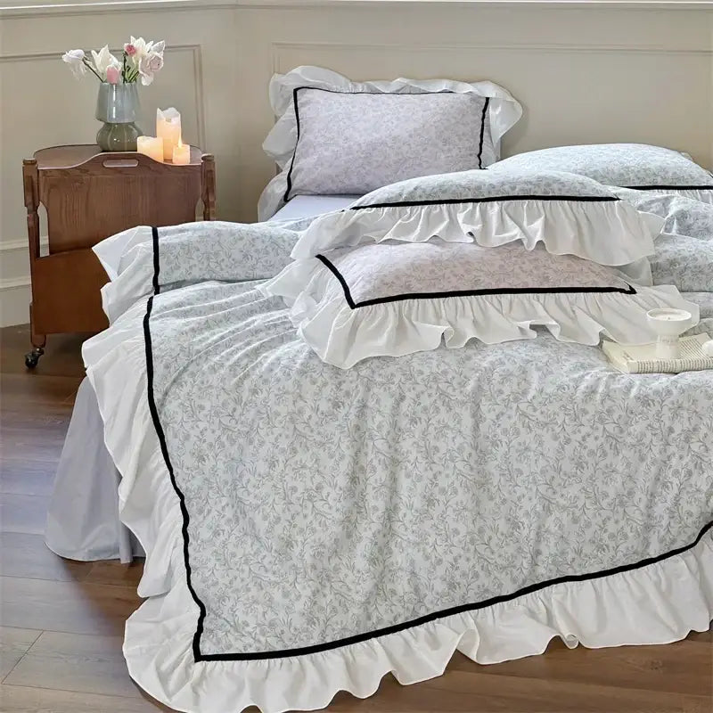 White ruffled decorbites cotton bedding set with delicate gray floral patterns and black trim for bedroom decor