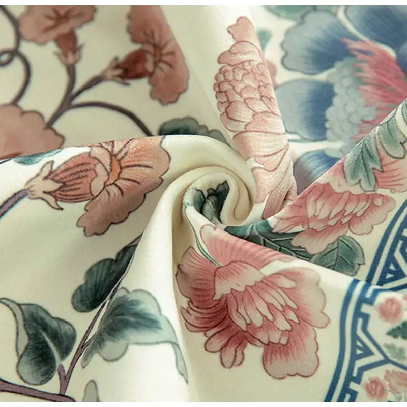 Cream-colored silk pillow cover with elegant pink peonies and blue geometric accents for flower fragrance pillow decor