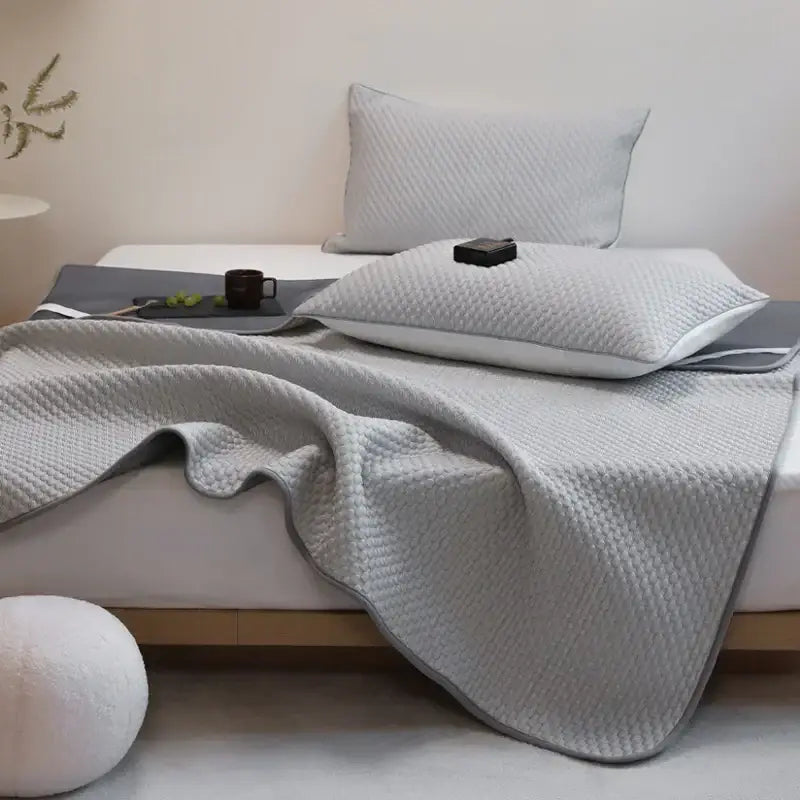 Light gray quilted bedspread with subtle texture and finished edges in decorbites ice bean bed sheet set for cooling sleep