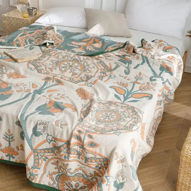 Light blue and gray patterned decorbites cotton gauze summer blanket with cream floral mandala design and solid green border