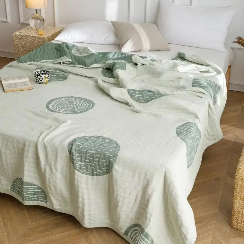 Light green and cream decorbites cotton gauze summer blanket with quilted circular pattern for bedroom decor