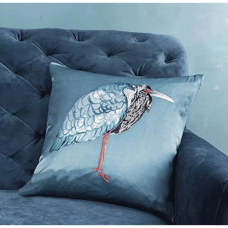Light blue heron embroidered silk throw pillow cover with plush teal paradise silk throw featuring detailed bird design