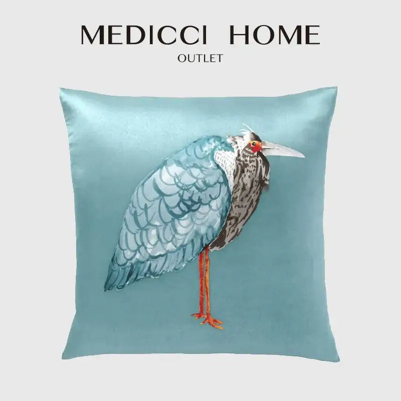 Light blue heron embroidered silk throw pillow cover featuring detailed feathers red eye and orange legs for living room