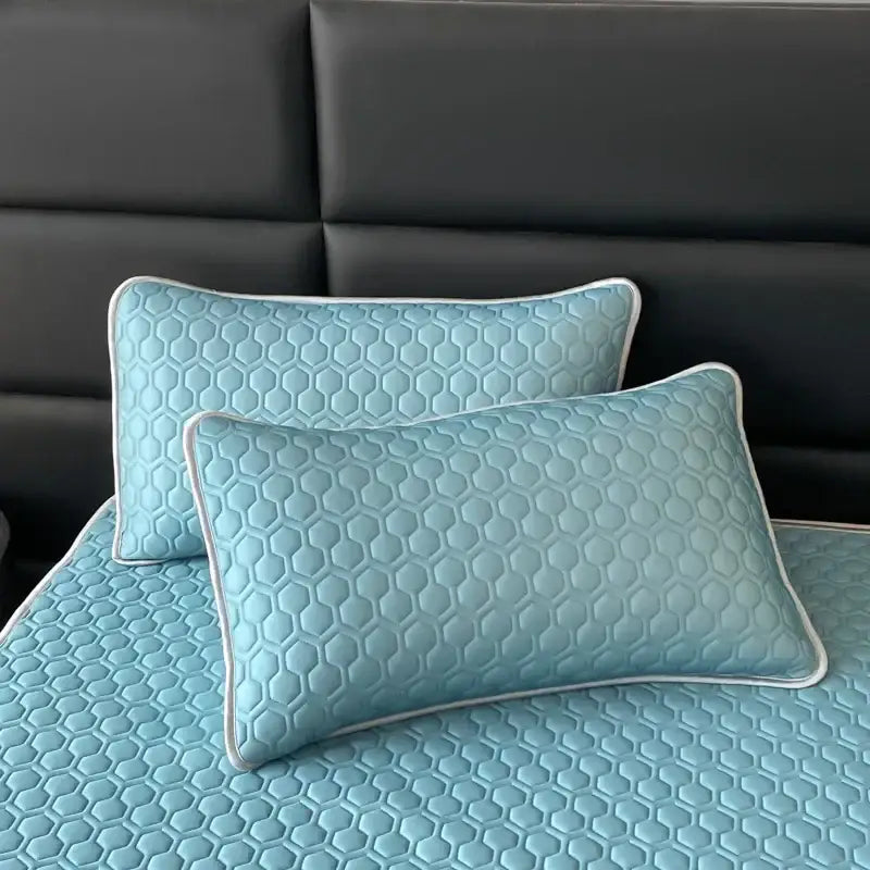Light blue hexagonal quilted pillow sham with white piping for latex filled bed mat cooling set in bedroom