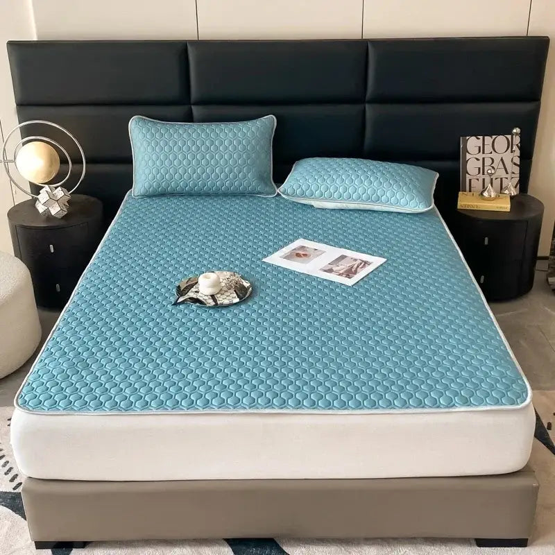 Light blue hexagonal cooling latex filled bed mat with quilted pattern and white piping for bedroom use