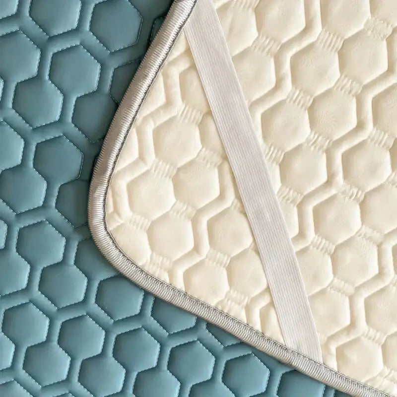 Cream-colored quilted cushion with hexagonal pattern and silver trim for light blue hexagonal cooling latex filled bed mat set