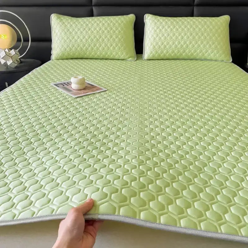 Light green hexagonal-patterned cooling latex filled bed mat with gray border for bedroom use