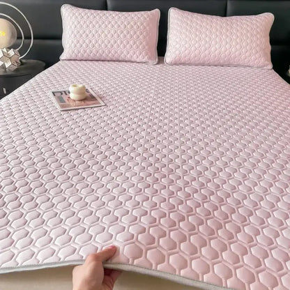 Pink hexagonal quilted bed mat with matching pillowcases featuring a latex filled bed mat design for bedroom use