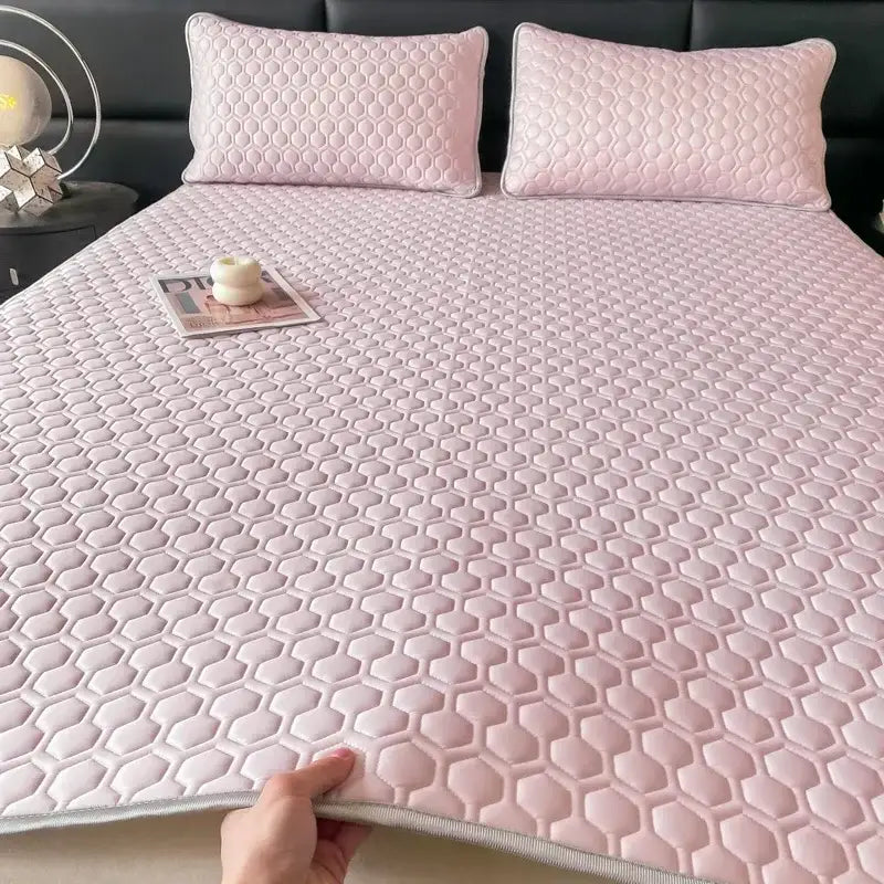 Pink hexagonal quilted bed mat with matching pillowcases featuring a latex filled bed mat design for bedroom use