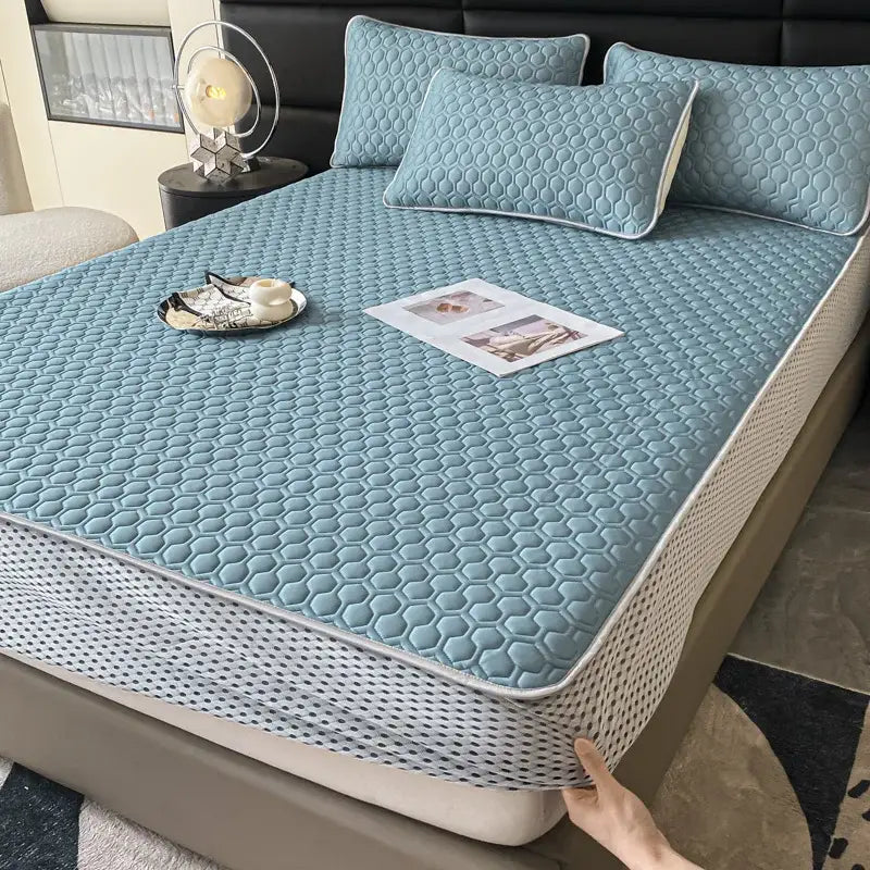 Light blue hexagonal ice silk cooling bed mat set with quilted pattern and white border for bedroom mattress protection