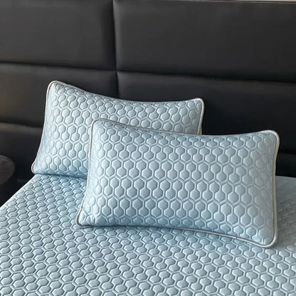 Light blue hexagonal ice silk cooling bed mat set with honeycomb quilted pillowcases and silver piping