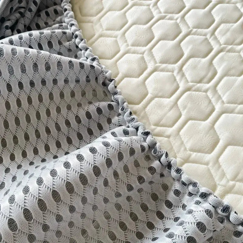 Gray lace bed skirt with ruffled edge paired with light blue hexagonal ice silk cooling bed mat set for bedroom use