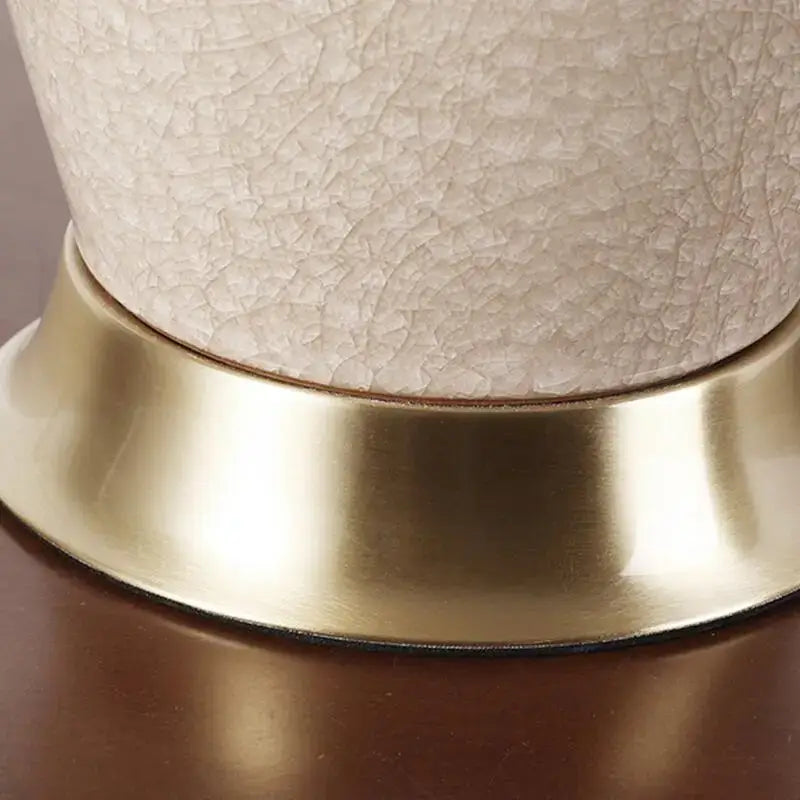 Cream-colored ice crack ceramic table lamp with textured finish and gold base for bedroom decorbites ice crack