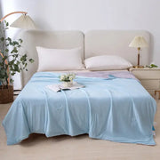 Light blue soft textured ice cream air conditioning quilt with subtle circular stitching for summer bedroom use