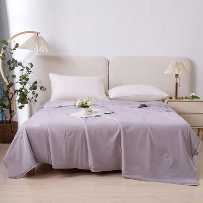 A soft lavender air conditioning quilt with subtle circular stitching ideal for light blue ice cream air summer use